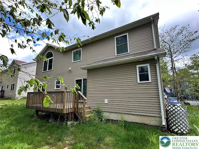 7190 Rimrock Dr, Coolbaugh Twp, PA 18466 - rear view of house with a wooden deck and a yard