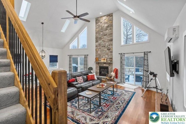 22 Petrarch Trl, Penn Forest Twp, PA 18210 - living area featuring high vaulted ceiling, a skylight, plenty of natural light, a wall mounted air conditioner, and wood finished floors