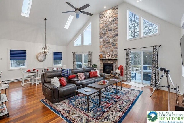 22 Petrarch Trl, Penn Forest Twp, PA 18210 - living room featuring high vaulted ceiling, ceiling fan, a stone fireplace, a skylight, and wood finished floors