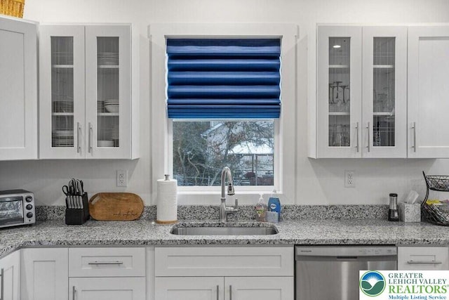 22 Petrarch Trl, Penn Forest Twp, PA 18210 - kitchen with dishwasher, a sink, white cabinetry, and glass insert cabinets