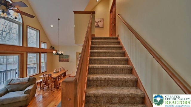 97 Lucretius Trl, Penn Forest Twp, PA 18210 - staircase featuring high vaulted ceiling, wood finished floors, and a chandelier