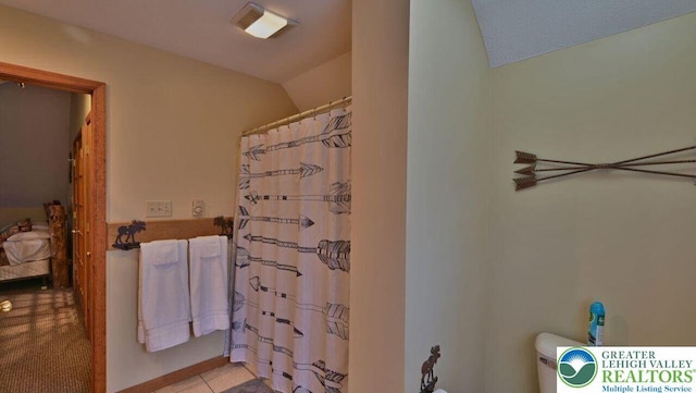 97 Lucretius Trl, Penn Forest Twp, PA 18210 - full bath featuring lofted ceiling, a shower with shower curtain, toilet, and tile patterned floors