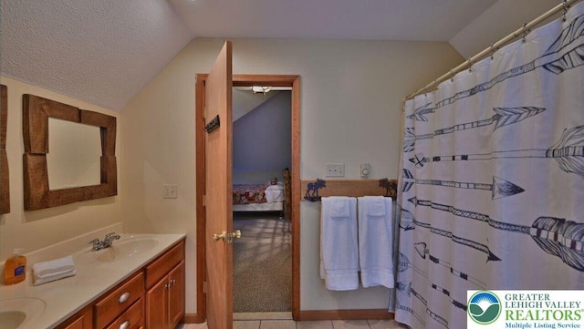 97 Lucretius Trl, Penn Forest Twp, PA 18210 - full bathroom featuring vaulted ceiling, connected bathroom, double vanity, and a textured ceiling