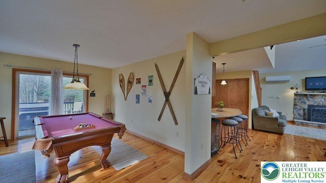 97 Lucretius Trl, Penn Forest Twp, PA 18210 - rec room featuring a wall unit AC, light wood finished floors, pool table, a fireplace, and baseboards