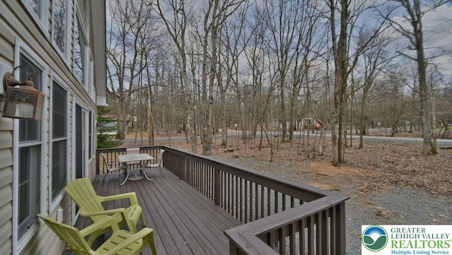 97 Lucretius Trl, Penn Forest Twp, PA 18210 - wooden terrace with outdoor dining space and view of scattered trees