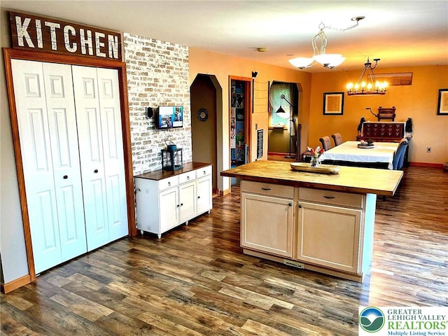968 Renaldi Rd, Bushkill Twp, PA 18091 - kitchen featuring butcher block countertops, dark wood-style flooring, hanging light fixtures, a chandelier, and a center island
