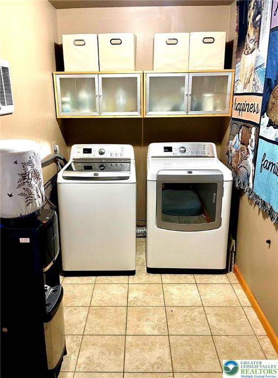 968 Renaldi Rd, Bushkill Twp, PA 18091 - laundry area featuring independent washer and dryer, cabinet space, light tile patterned flooring, and baseboards