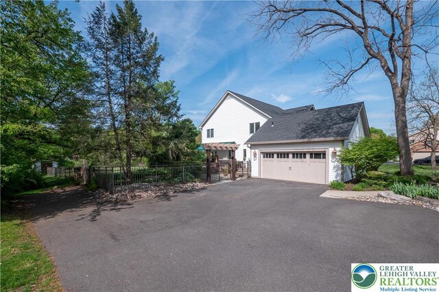 1560 Surrey Rd, Lower Saucon Twp, PA 18015 - view of side of home featuring driveway, an attached garage, and a shingled roof