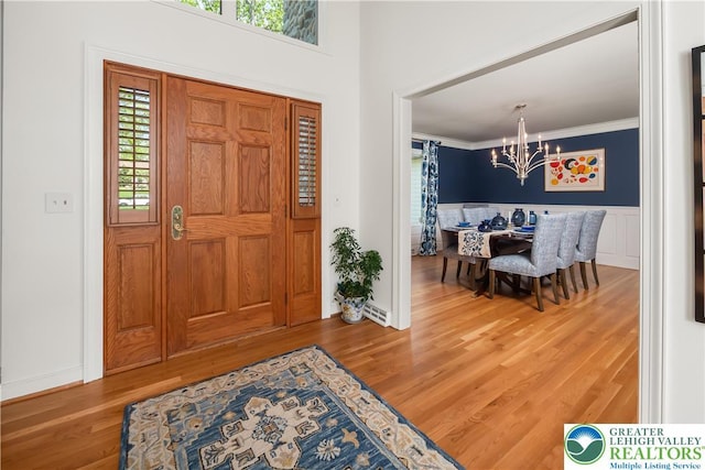 1560 Surrey Rd, Lower Saucon Twp, PA 18015 - entrance foyer with a chandelier, plenty of natural light, wood finished floors, crown molding, and wainscoting