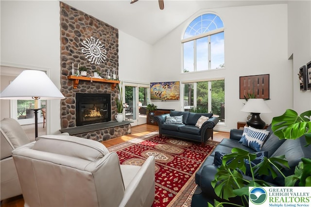 1560 Surrey Rd, Lower Saucon Twp, PA 18015 - living room with high vaulted ceiling, a stone fireplace, wood finished floors, ceiling fan, and plenty of natural light