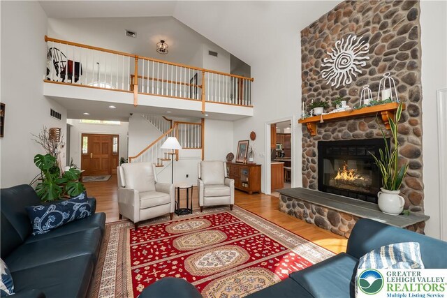 1560 Surrey Rd, Lower Saucon Twp, PA 18015 - living area featuring wood finished floors, high vaulted ceiling, stairway, and a fireplace