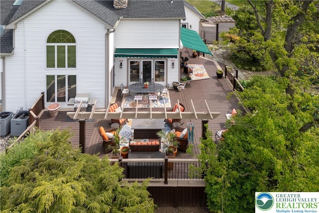 1560 Surrey Rd, Lower Saucon Twp, PA 18015 - back of property featuring a wooden deck, a shingled roof, french doors, and outdoor dining area