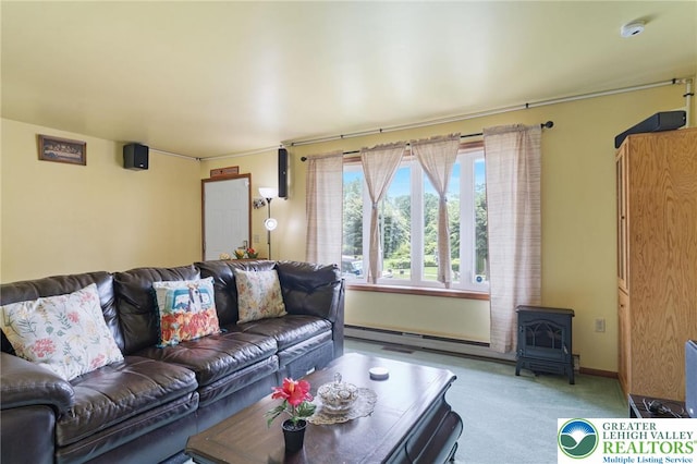 94 Brader Dr, Luzerne, PA 18705 - living room with carpet floors, a wood stove, and baseboards