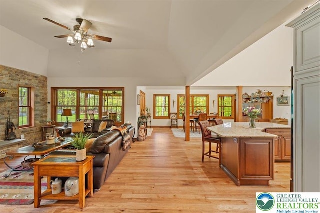 127 Timber Lake Dr, Barrett Twp, PA 18325 - living area with high vaulted ceiling, light wood-style flooring, and a ceiling fan