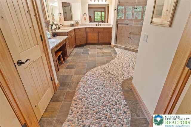 127 Timber Lake Dr, Barrett Twp, PA 18325 - full bath featuring stone tile flooring, a shower stall, double vanity, and baseboards