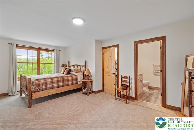 127 Timber Lake Dr, Barrett Twp, PA 18325 - bedroom with light colored carpet, baseboards, and ensuite bath