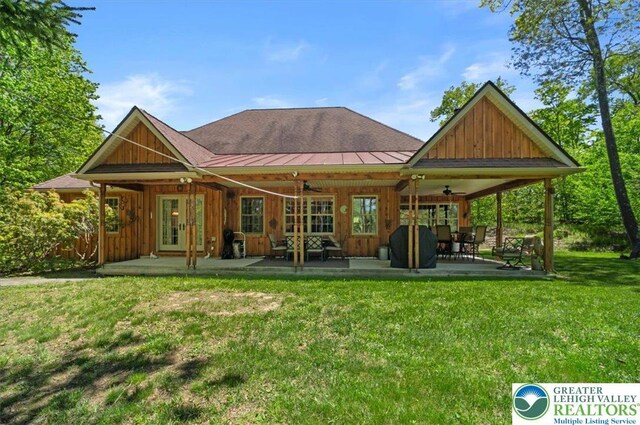 127 Timber Lake Dr, Barrett Twp, PA 18325 - rear view of house with ceiling fan, a lawn, a patio area, board and batten siding, and french doors
