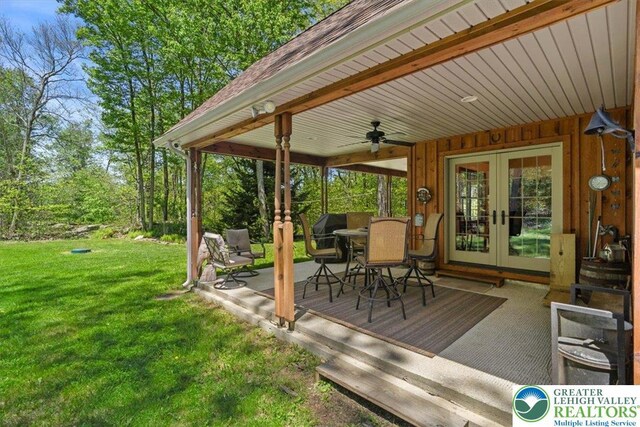 127 Timber Lake Dr, Barrett Twp, PA 18325 - wooden terrace featuring french doors, ceiling fan, and a yard