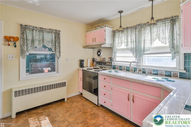 6386 Sullivan Trl, Plainfield Twp, PA 18091 - kitchen featuring radiator, white electric range, a sink, tile counters, and pendant lighting
