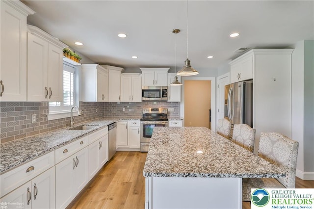 217 E Dell Rd, Moore Twp, PA 18014 - kitchen featuring appliances with stainless steel finishes, a sink, a kitchen island, white cabinets, and recessed lighting