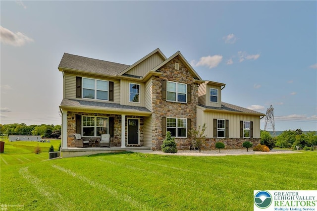 217 E Dell Rd, Moore Twp, PA 18014 - craftsman-style house featuring stone siding, board and batten siding, a porch, and a front lawn