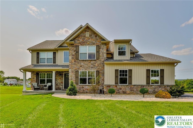 217 E Dell Rd, Moore Twp, PA 18014 - craftsman inspired home with stone siding, a front yard, a porch, and board and batten siding