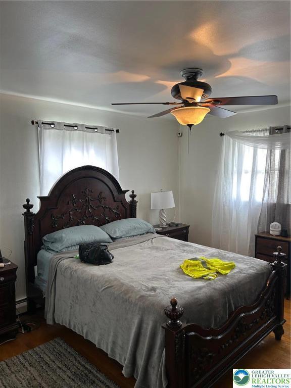 226 E Walnut St, Allentown City, PA 18109 - bedroom featuring wood finished floors, a ceiling fan, and a baseboard radiator