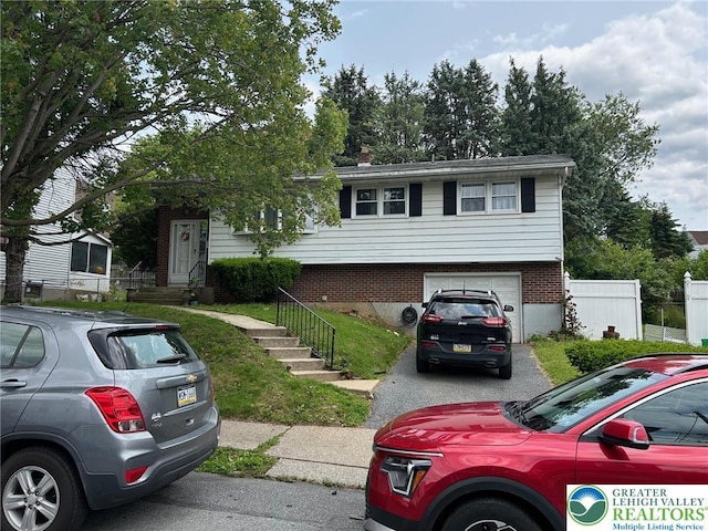 226 E Walnut St, Allentown City, PA 18109 - view of front facade featuring an attached garage, brick siding, and driveway