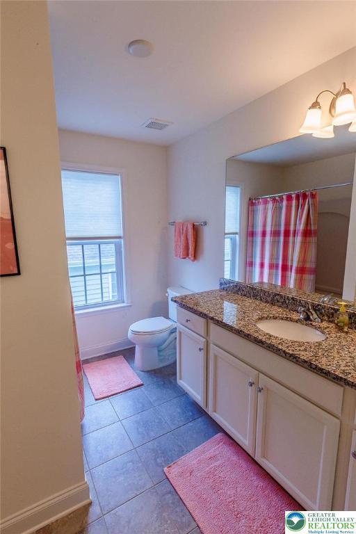 1069 Resolution Dr, Bethlehem City, PA 18017 - bathroom featuring vanity, tile patterned floors, and curtained shower