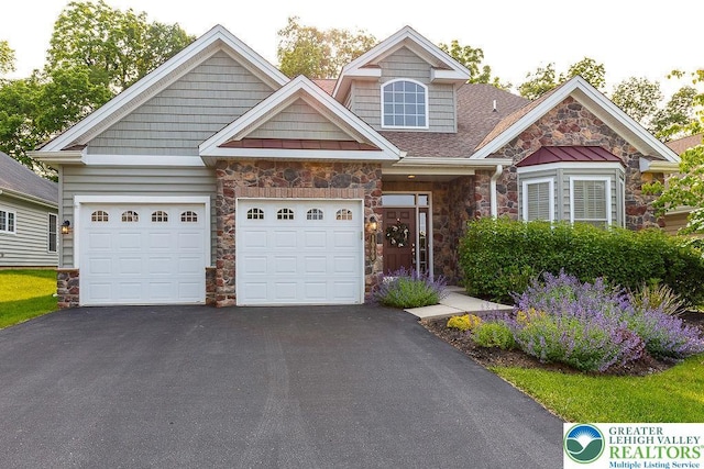 1069 Resolution Dr, Bethlehem City, PA 18017 - view of front of property featuring stone siding, driveway, a garage, and a shingled roof