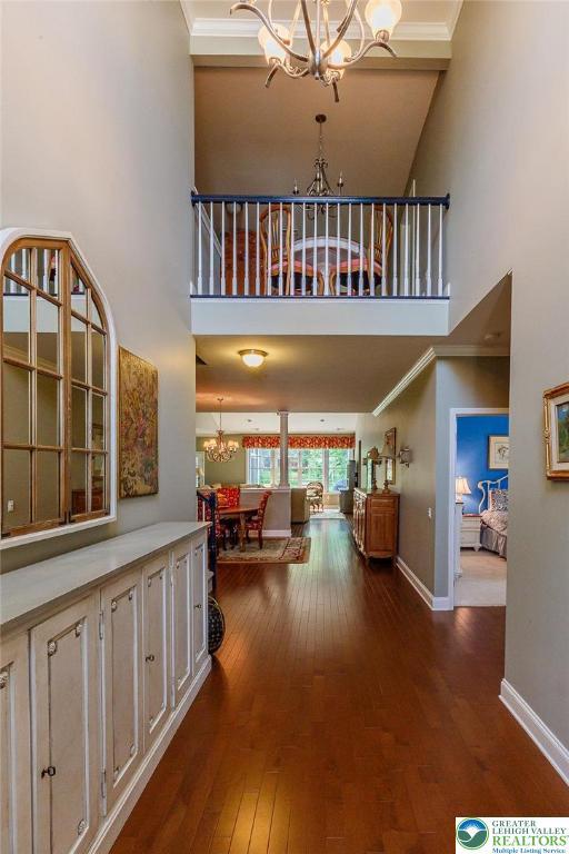 1069 Resolution Dr, Bethlehem City, PA 18017 - corridor with a chandelier, a high ceiling, hardwood / wood-style flooring, and ornamental molding