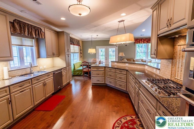 1069 Resolution Dr, Bethlehem City, PA 18017 - kitchen featuring stainless steel appliances, a peninsula, tasteful backsplash, hanging light fixtures, and dark stone counters