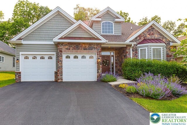 1069 Resolution Dr, Bethlehem City, PA 18017 - view of front of house featuring stone siding, asphalt driveway, a garage, and a shingled roof