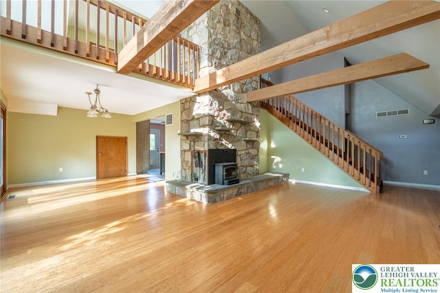 68 Knoll Cir, Boyertown, PA 19512 - unfurnished living room featuring high vaulted ceiling, wood finished floors, baseboards, and stairway