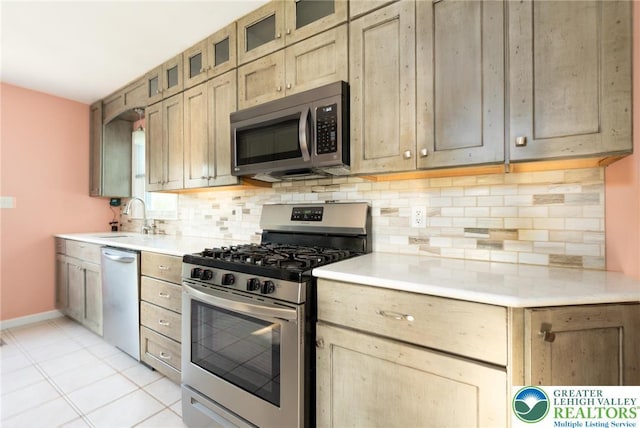 68 Knoll Cir, Boyertown, PA 19512 - kitchen with appliances with stainless steel finishes, a sink, tasteful backsplash, light countertops, and glass insert cabinets