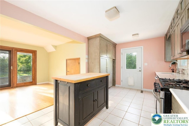 68 Knoll Cir, Boyertown, PA 19512 - kitchen with a sink, light tile patterned flooring, gas range, baseboards, and butcher block counters