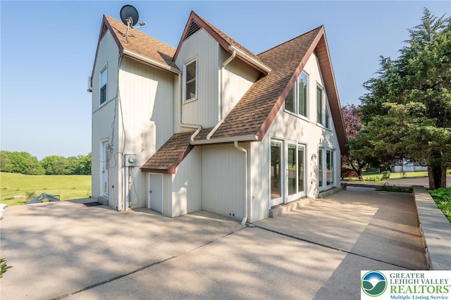68 Knoll Cir, Boyertown, PA 19512 - back of house featuring a shingled roof and a patio area