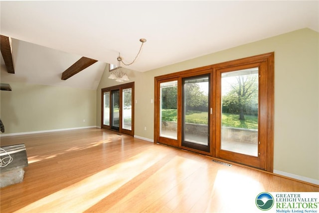 68 Knoll Cir, Boyertown, PA 19512 - unfurnished living room with lofted ceiling, wood finished floors, baseboards, and french doors