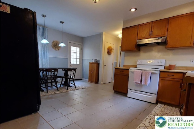 374 Nesquehoning St, Easton, PA 18042 - kitchen with white electric range, under cabinet range hood, brown cabinets, light countertops, and freestanding refrigerator