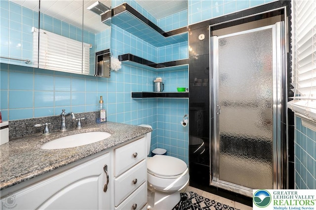 990 Hill Dr, Lower Macungie Twp, PA 18103 - bathroom featuring tile walls, vanity, a shower stall, and toilet
