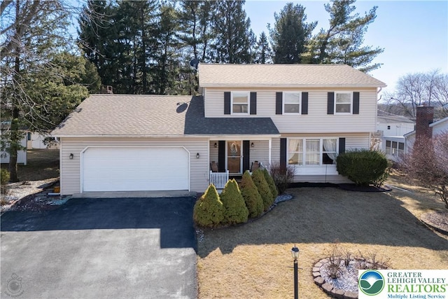 990 Hill Dr, Lower Macungie Twp, PA 18103 - view of front of home with driveway, a garage, a shingled roof, and a porch