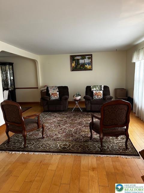 990 Hill Dr, Lower Macungie Twp, PA 18103 - living room featuring hardwood / wood-style floors and arched walkways