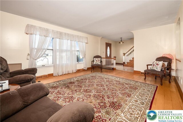 990 Hill Dr, Lower Macungie Twp, PA 18103 - living room featuring wood-type flooring, stairway, and baseboards