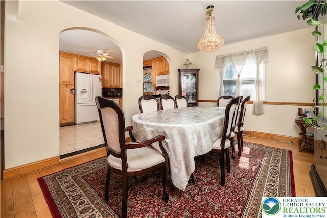 990 Hill Dr, Lower Macungie Twp, PA 18103 - dining space featuring arched walkways, light wood-type flooring, ceiling fan, baseboards, and vaulted ceiling