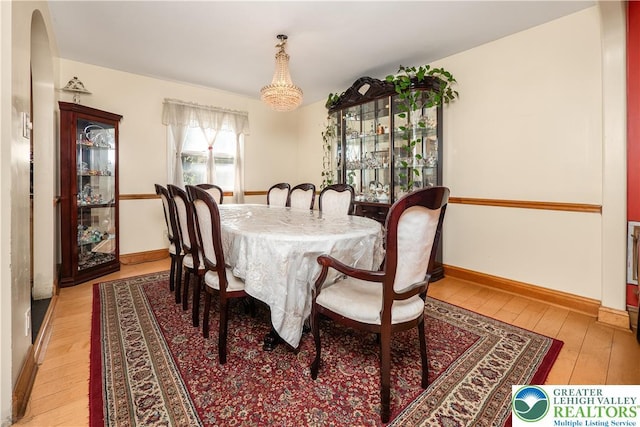 990 Hill Dr, Lower Macungie Twp, PA 18103 - dining room featuring light wood-type flooring, arched walkways, and baseboards