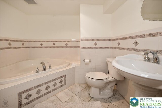 990 Hill Dr, Lower Macungie Twp, PA 18103 - bathroom with a bath, toilet, and a wainscoted wall