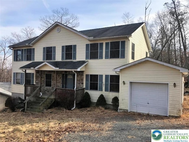 271 St Andrews Dr, Middle Smithfield Twp, PA 18324 - view of front of house with a porch, a garage, and gravel driveway