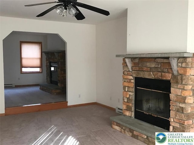 271 St Andrews Dr, Middle Smithfield Twp, PA 18324 - unfurnished living room featuring a stone fireplace, carpet floors, a baseboard radiator, baseboard heating, and a ceiling fan