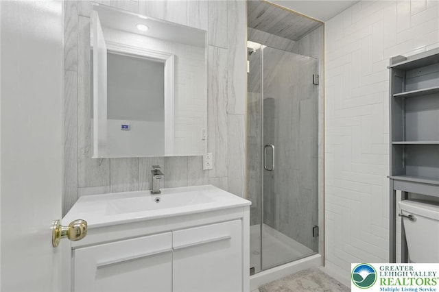 116 Peechatka, Pocono Twp, PA 18332 - bathroom with vanity, a stall shower, toilet, and tile walls