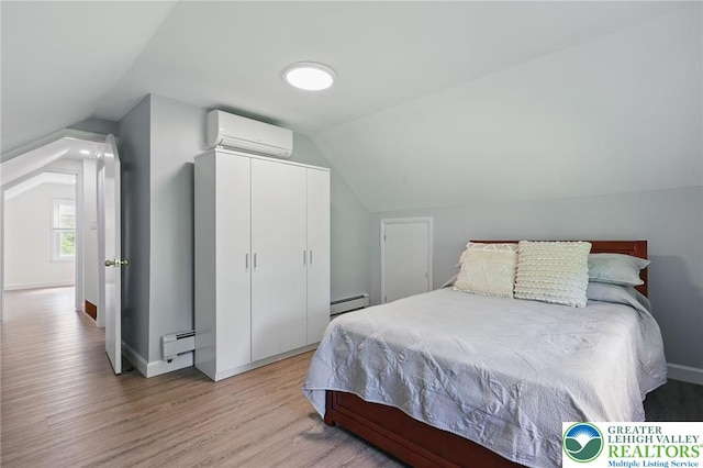 116 Peechatka, Pocono Twp, PA 18332 - bedroom featuring an AC wall unit, vaulted ceiling, light wood-style floors, baseboard heating, and a closet